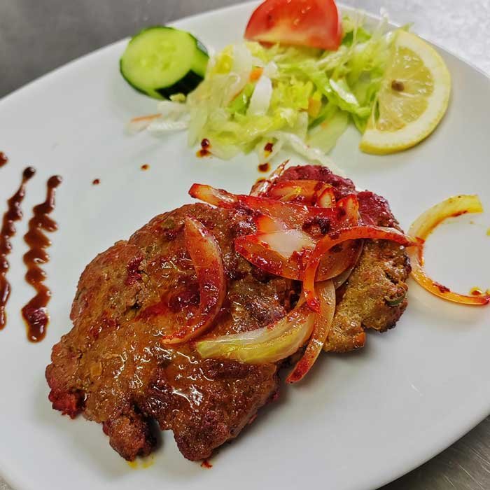 Shami kebab with fresh salad and fried onions at an Indian Restaurant in Brighouse - Swadish